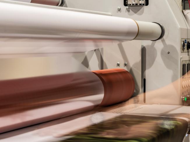 A long exposure photo of transparent packaging film being made.